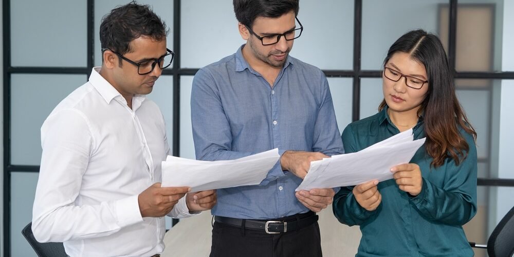 Multiethnic business team analyzing financial reports